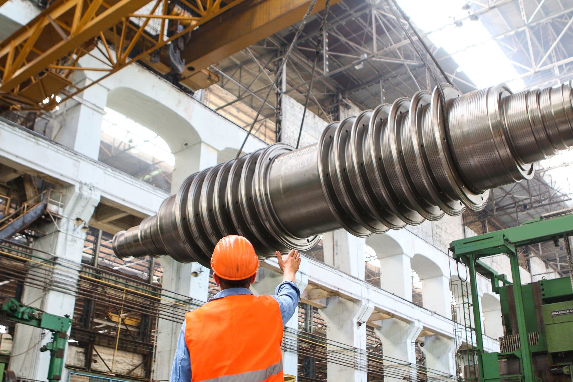 Technicians servicing heavy industrial lifting equipment